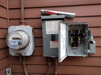 Solar AC disconnect on the right
