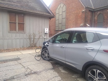Electric car being charged with solar power